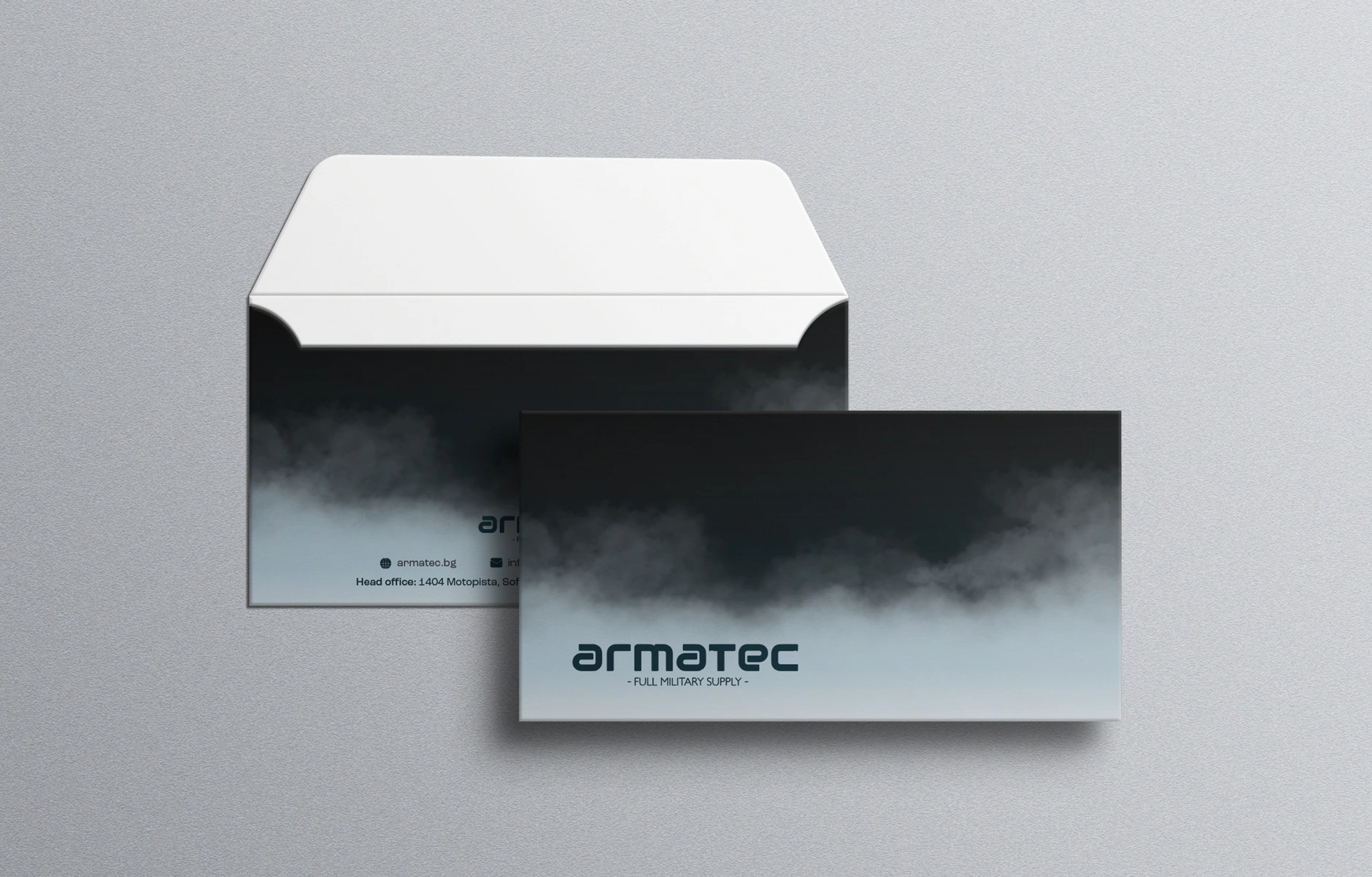 Armatec branded envelope and card mockup with the logo set against a dark smoke gradient